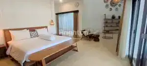 Bright and spacious bedroom in Villa Seulas, Berawa with contemporary decor and large windows.