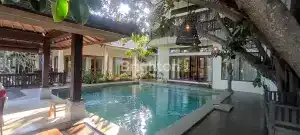 Pool area of Villa Seluas with lush greenery and modern design in Berawa.
