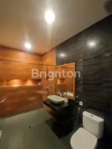 Bathroom with stylish black and wooden accents in a modern villa.