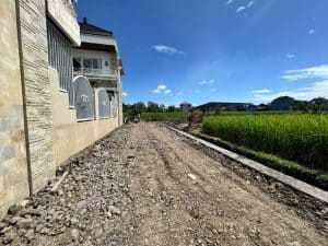 Vacant land plot in Pandak Gede with yellow zone designation, ready for building.