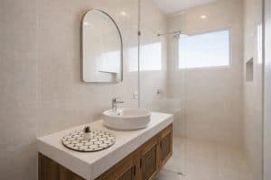 Bright tropical villa bathroom with minimalist design and natural light.