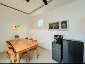 Brighton Villa dining space near Nuanu Creative City with scenic sawah views at Nyanyi Beach.