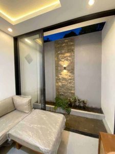 Modern villa with water feature and garden view.