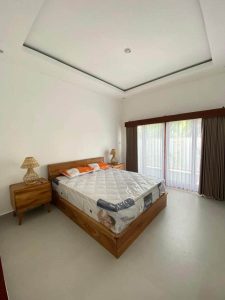 Spacious bedroom featuring a new mattress, wooden furniture, and large windows overlooking Yeh Gangg.