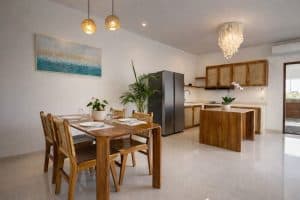 Bright modern tropical villa kitchen with wooden accents and elegant lighting.