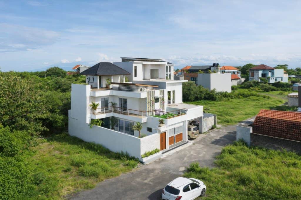 Luxury modern tropical villa with three floors in Nusa Dua, featuring spacious terraces and lush sur.