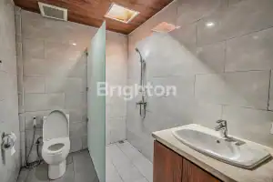 Modern Bali-style bathroom with walk-in shower and toilet.