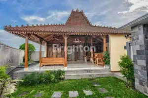 Traditional Joglo villa with a private pool in Kerobokan, Bali, perfect for a relaxing getaway.