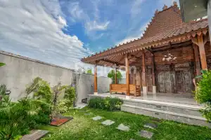 Joglo villa with lush garden and private pool in Kerobokan, Bali, perfect for relaxing stays.