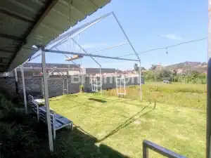 Outdoor space for restaurant or cafe in Kerobokan, Bali, with a partially dismantled roof structure.