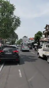 Busy street view of Jl. Diponegoro Denpasar showcasing commercial land location.